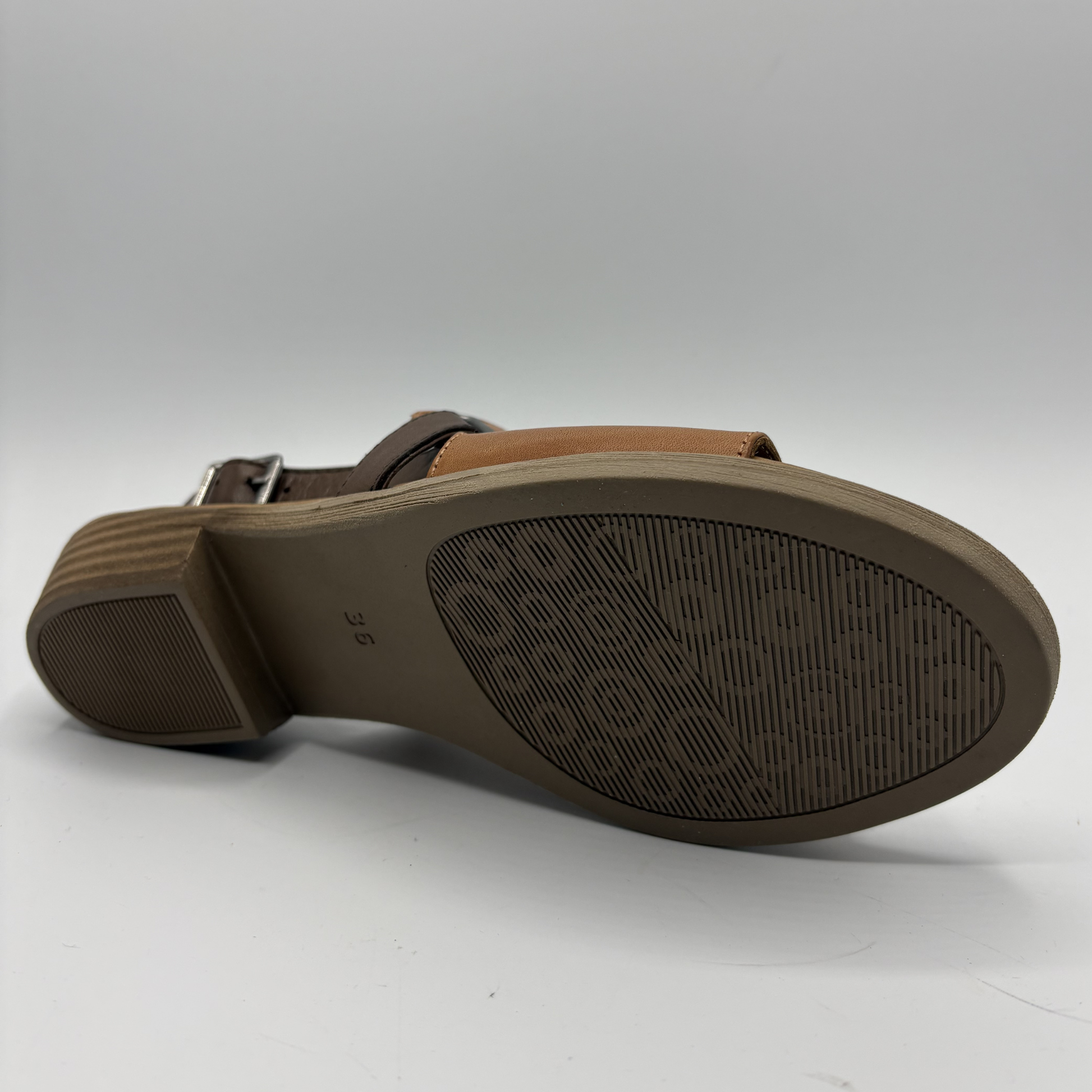 Brown sandal sole with brand logo on a white background