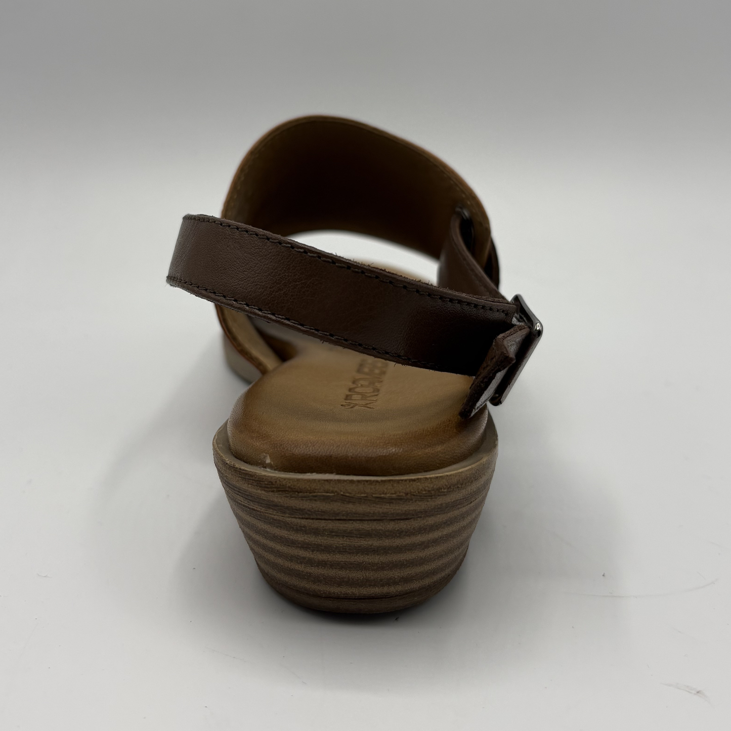 Brown sandal with a strap on a white background