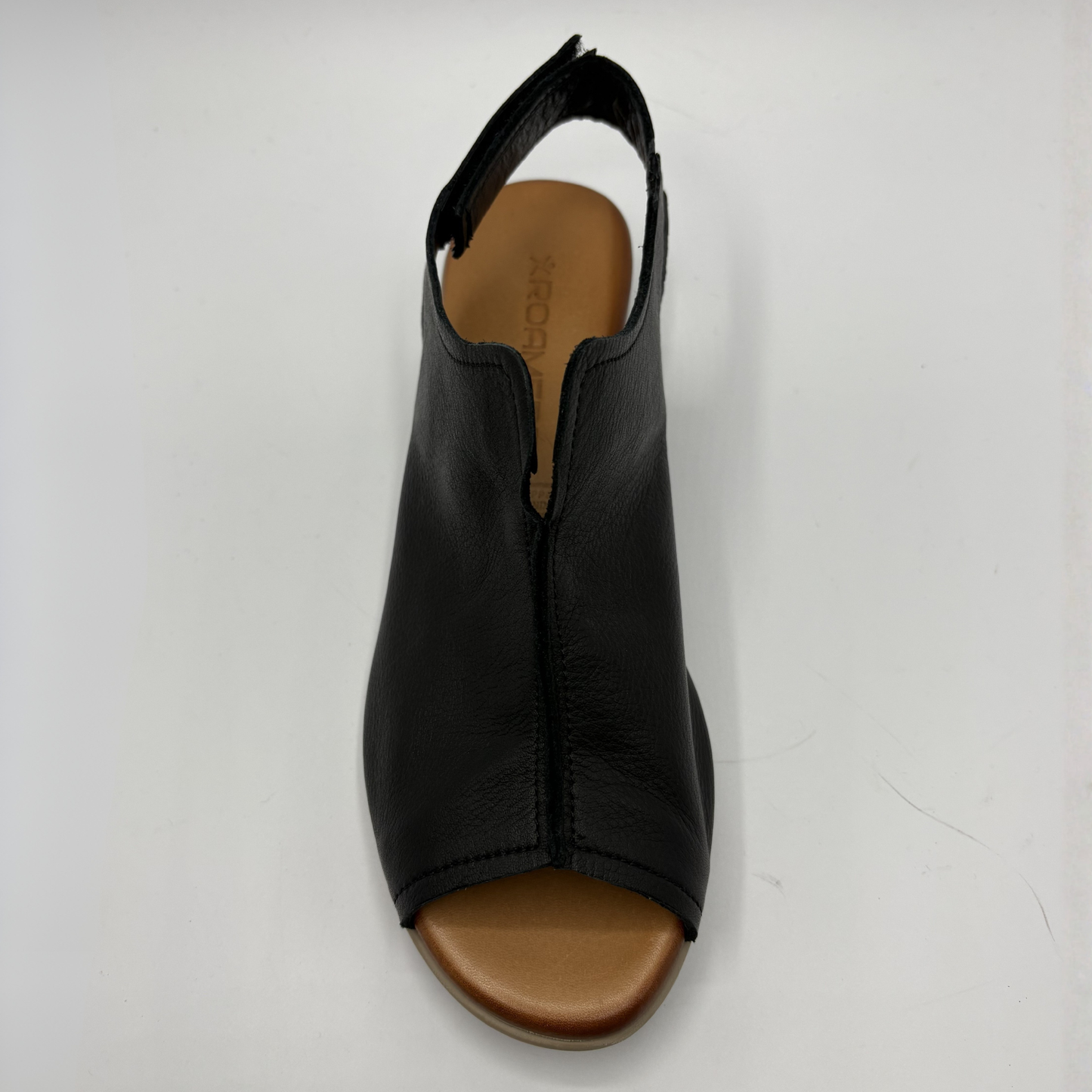 Black sandal with brown sole on a white background