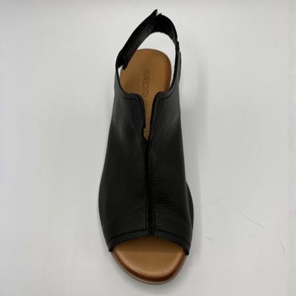 Black sandal with brown sole on a white background