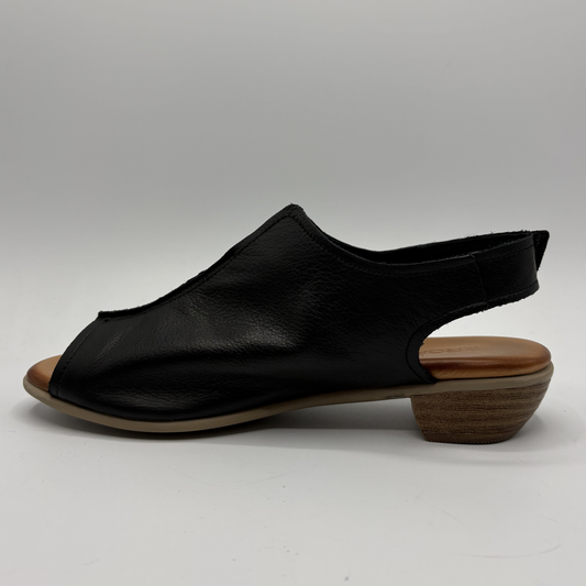 Black sandal with wooden sole on a gray background