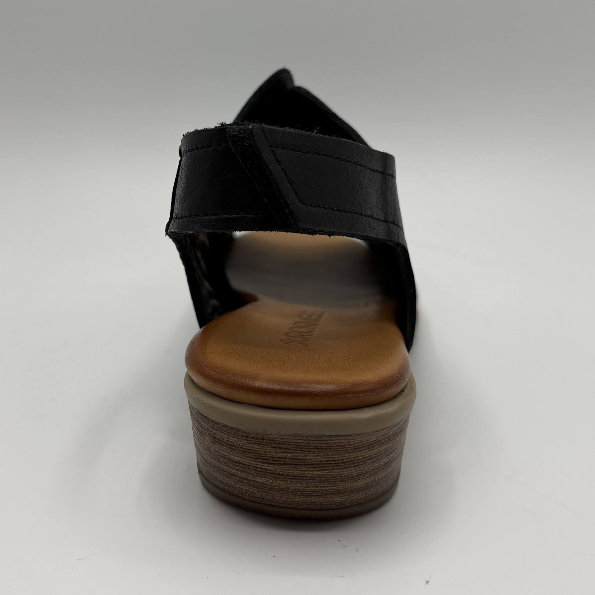 Black sandal with wooden sole on a white background