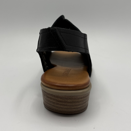 Black sandal with wooden sole on a white background