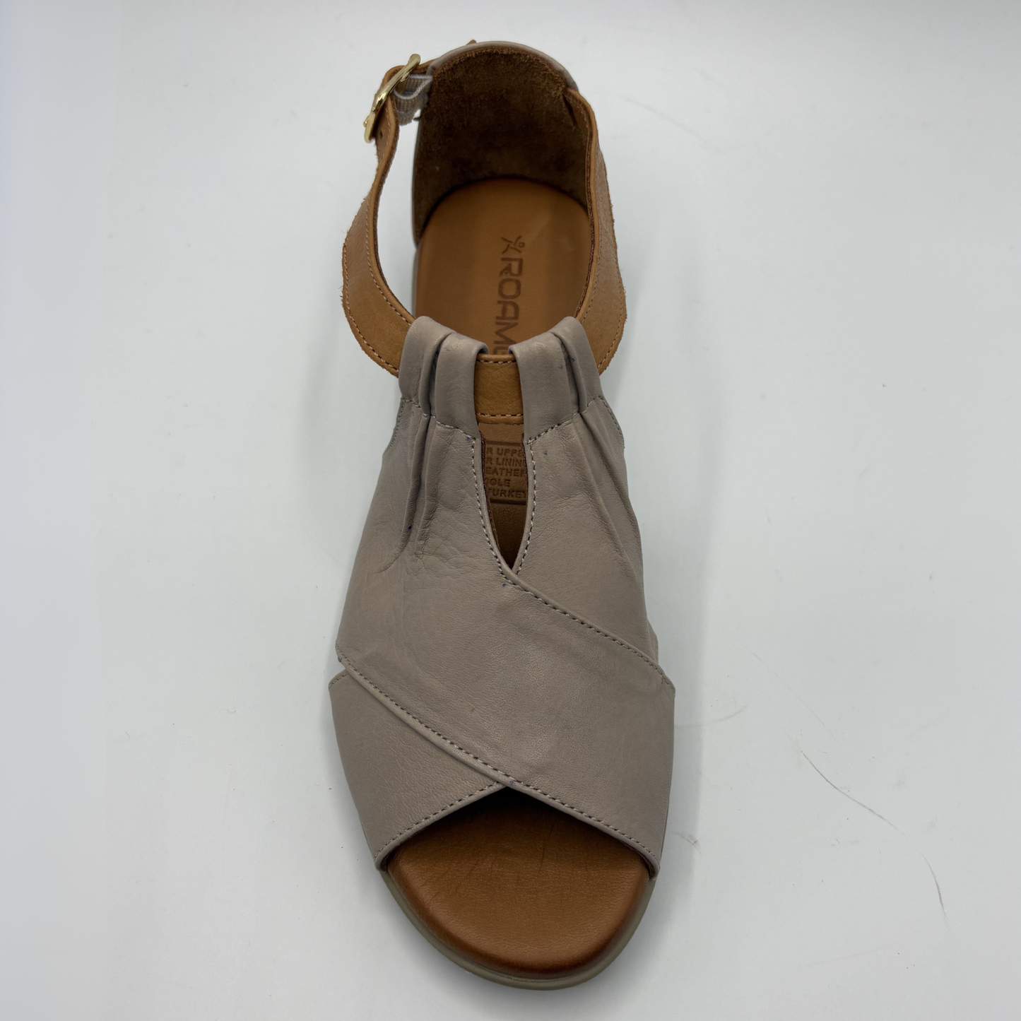 Taupe sandal with a brown sole on a white background