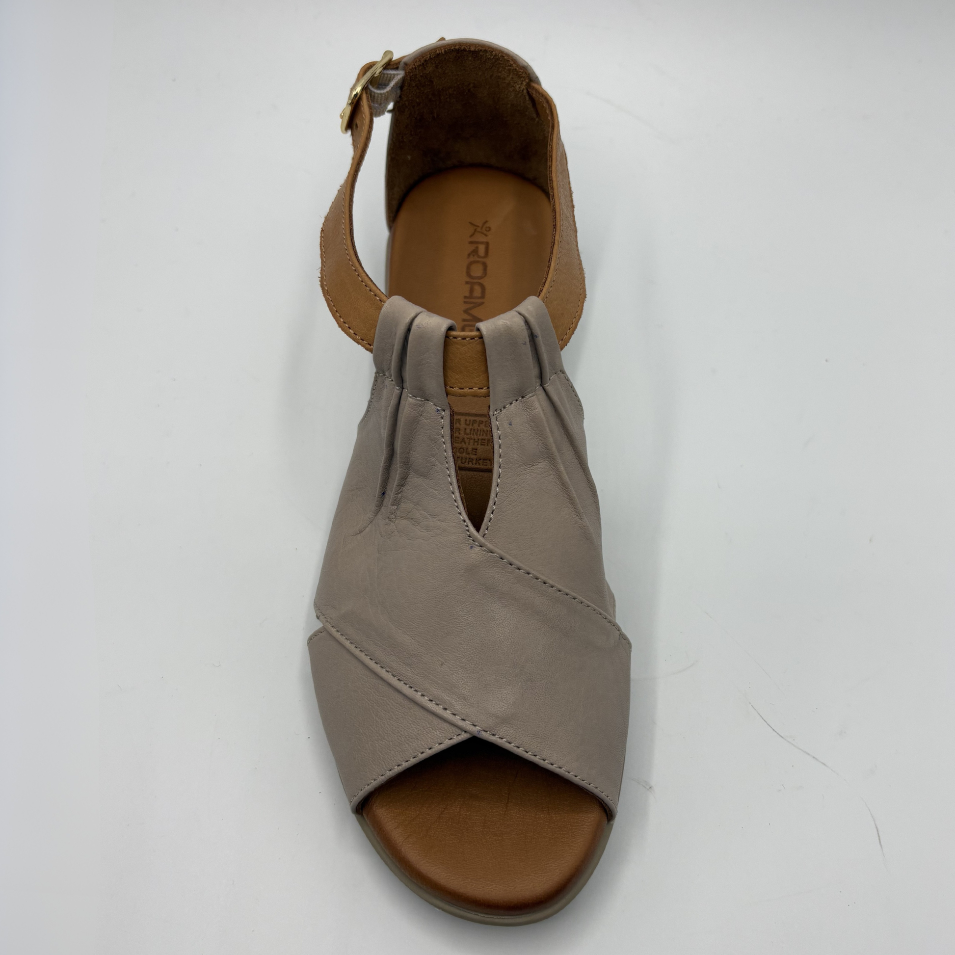 Taupe sandal with a brown sole on a white background