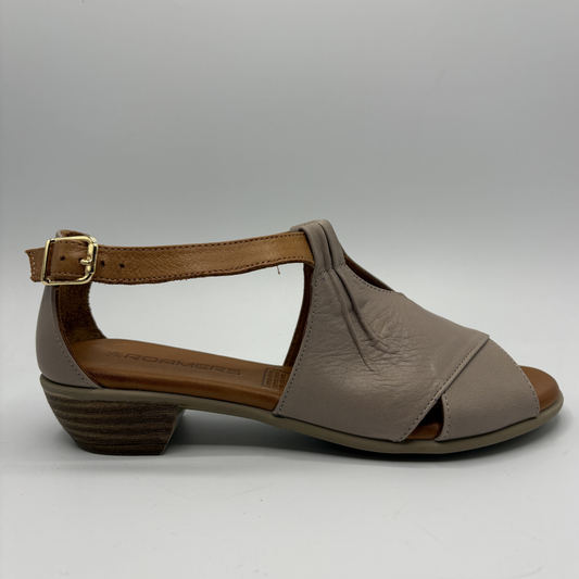 Brown sandal with a strap and buckle on a gray background