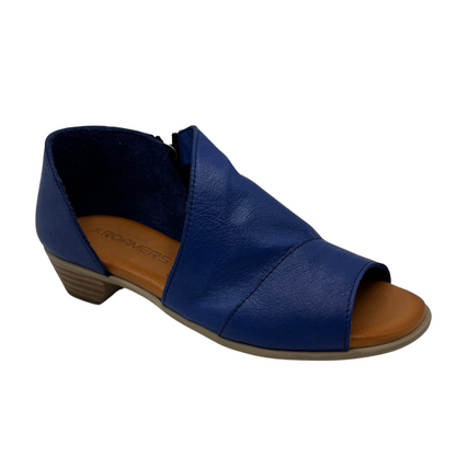 45 degree angled view of blue leather sandal with peep toe and open side design