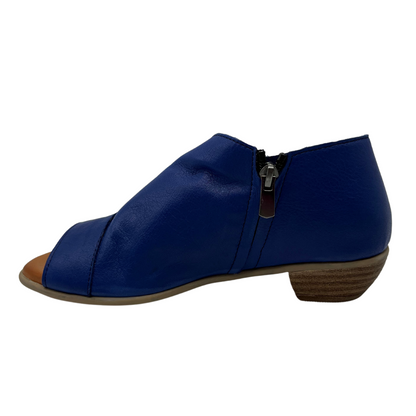 Left facing view of blue leather sandal with side zipper, short heel and open side design