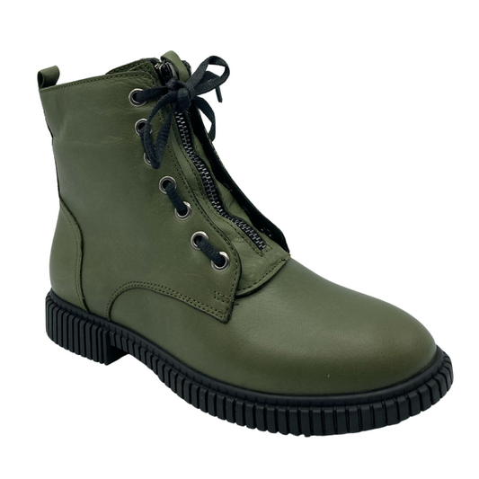 45 degree angled view of olive green leather boot with black rubber outsole