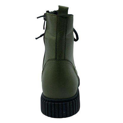 Back view of olive green leather boot with black rubber outsole and heel pull on tab