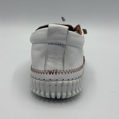 Back view of a white leather shoe with off center laces
