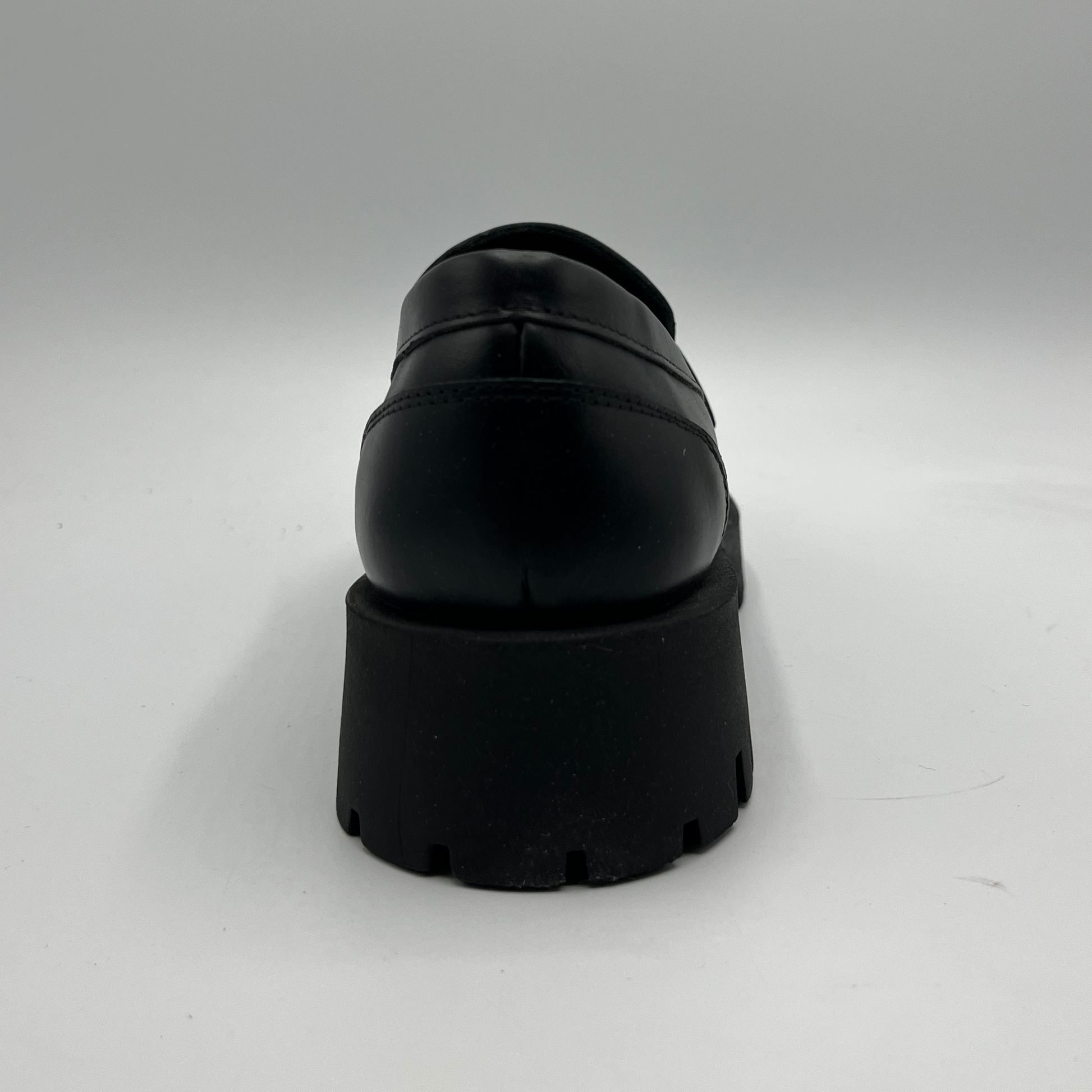 Black platform loafer on a white background