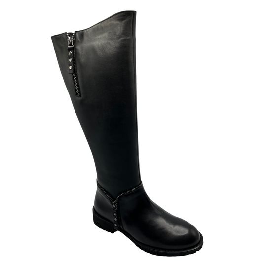 45 degree angled view of a black leather tall boot with two side zipper closures, zipper accent around ankle and also features a low block heel