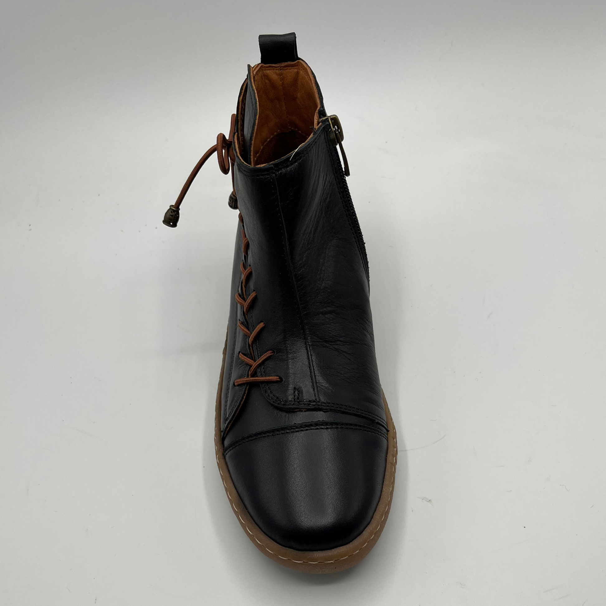 Black leather boot with brown laces on a white background