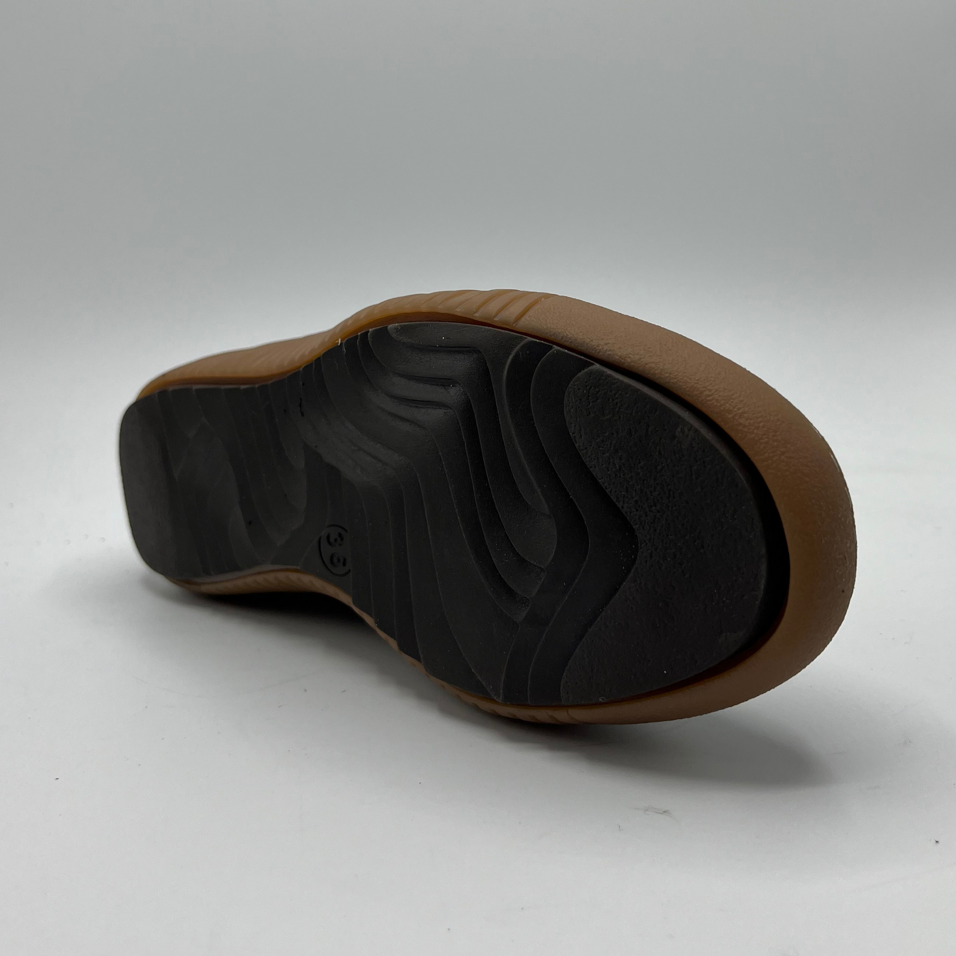 Brown and black shoe sole on a white background