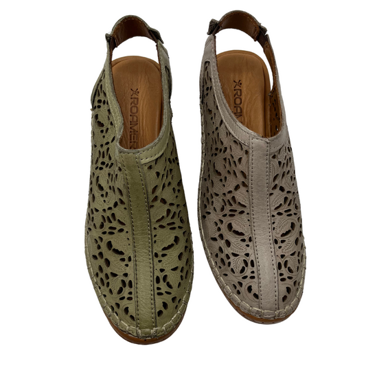 Top view of two leather shoes beside each other. Both with elastic back straps, rounded toes and leather lined