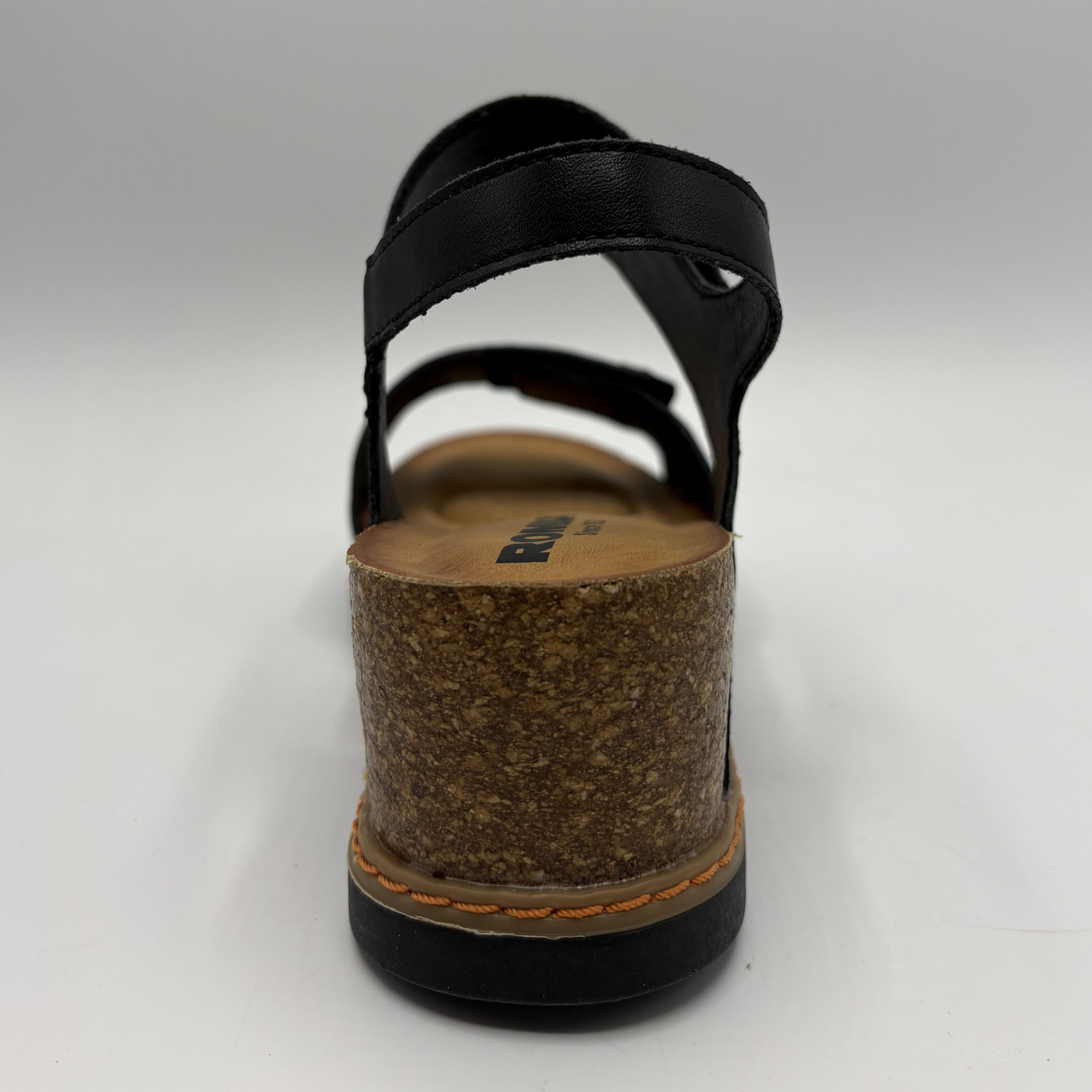 Black sandal with cork sole on a gray background