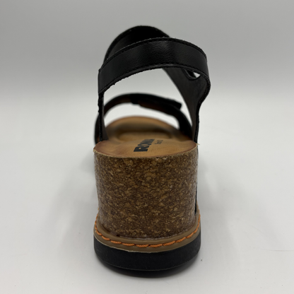 Black sandal with cork sole on a gray background