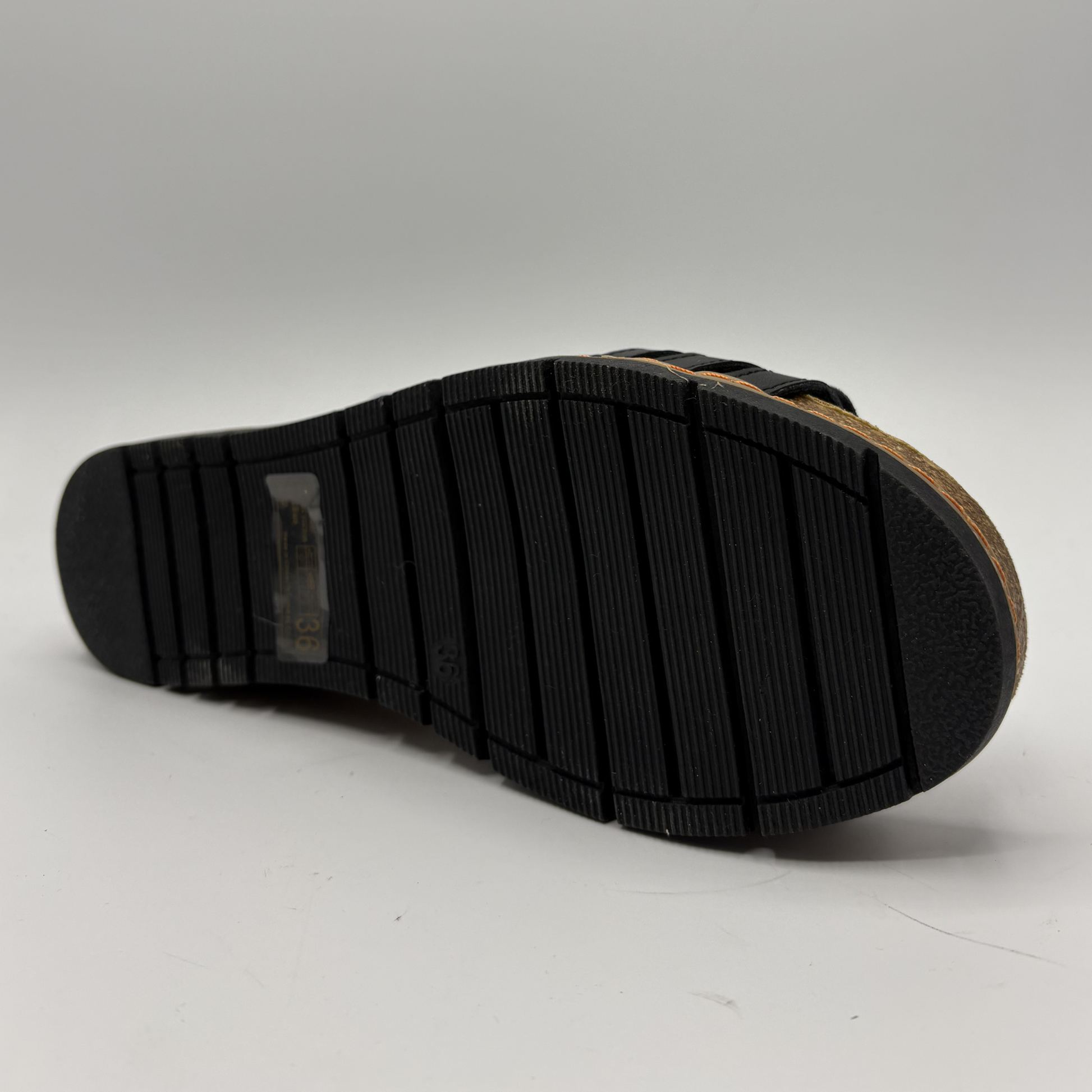 Black sole of a shoe on a gray background