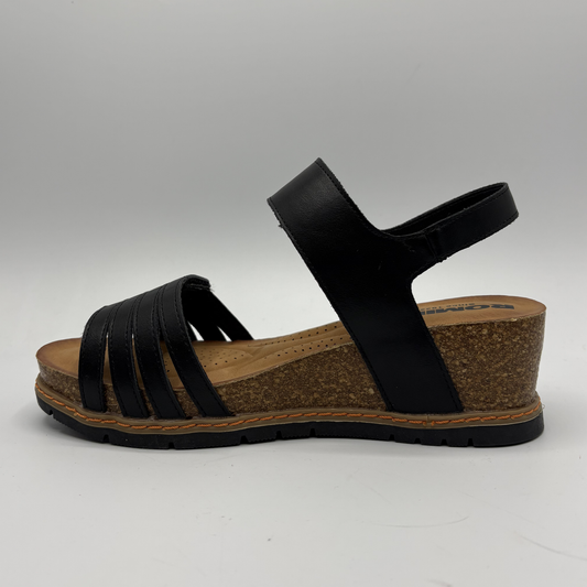 Black sandal with cork sole on a gray background