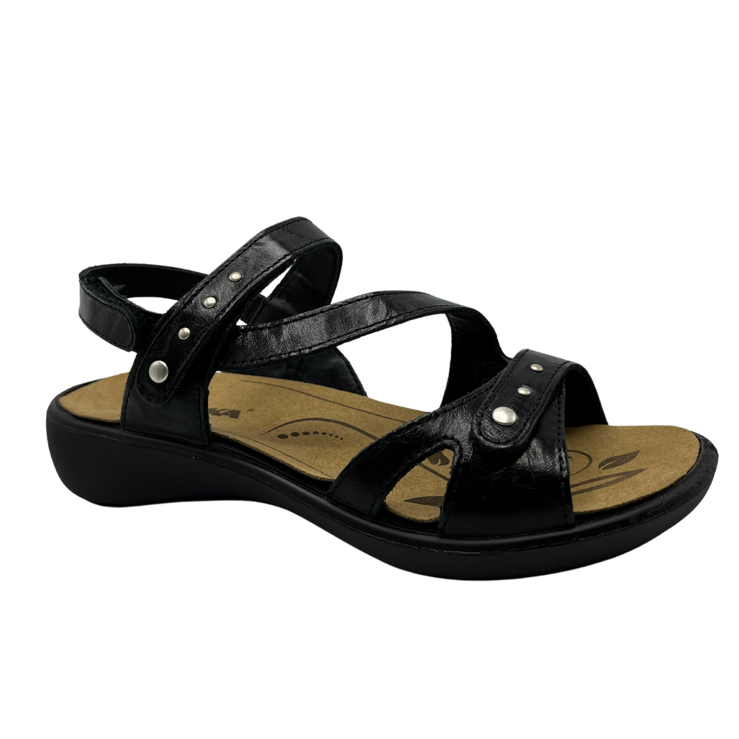 45 degree angled view of black leather sandal with brown lining and silver studs on straps