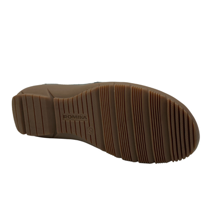 Bottom view of black leather shoe with brown rubber outsole