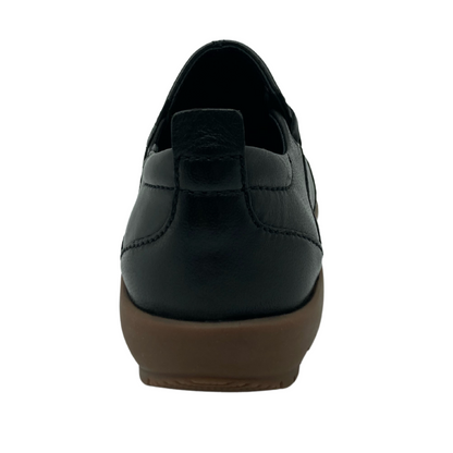 Back view of black leather shoe with brown rubber outsole
