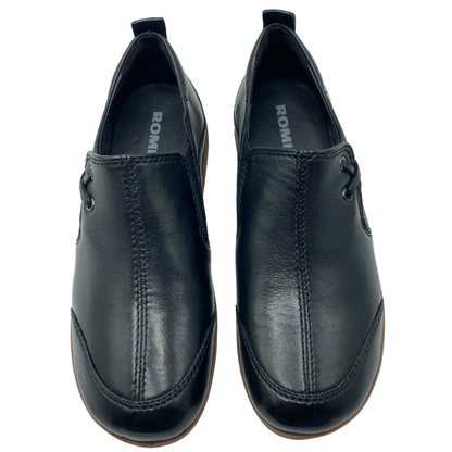 Top view of a pair of black leather shoes with a rounded toe and black inner lining