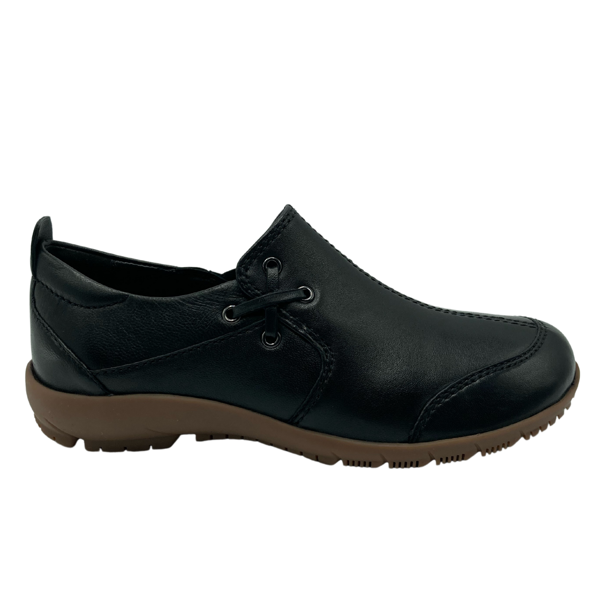 Right facing view of black leather shoe with crossed lace detail on the side with a brown rubber outsole