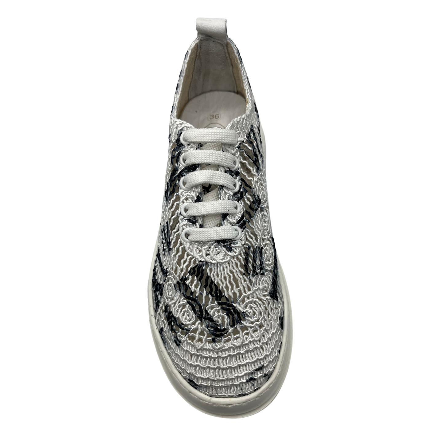 Top view of white and black mesh sneaker with ultralight white platform sole with white laces.