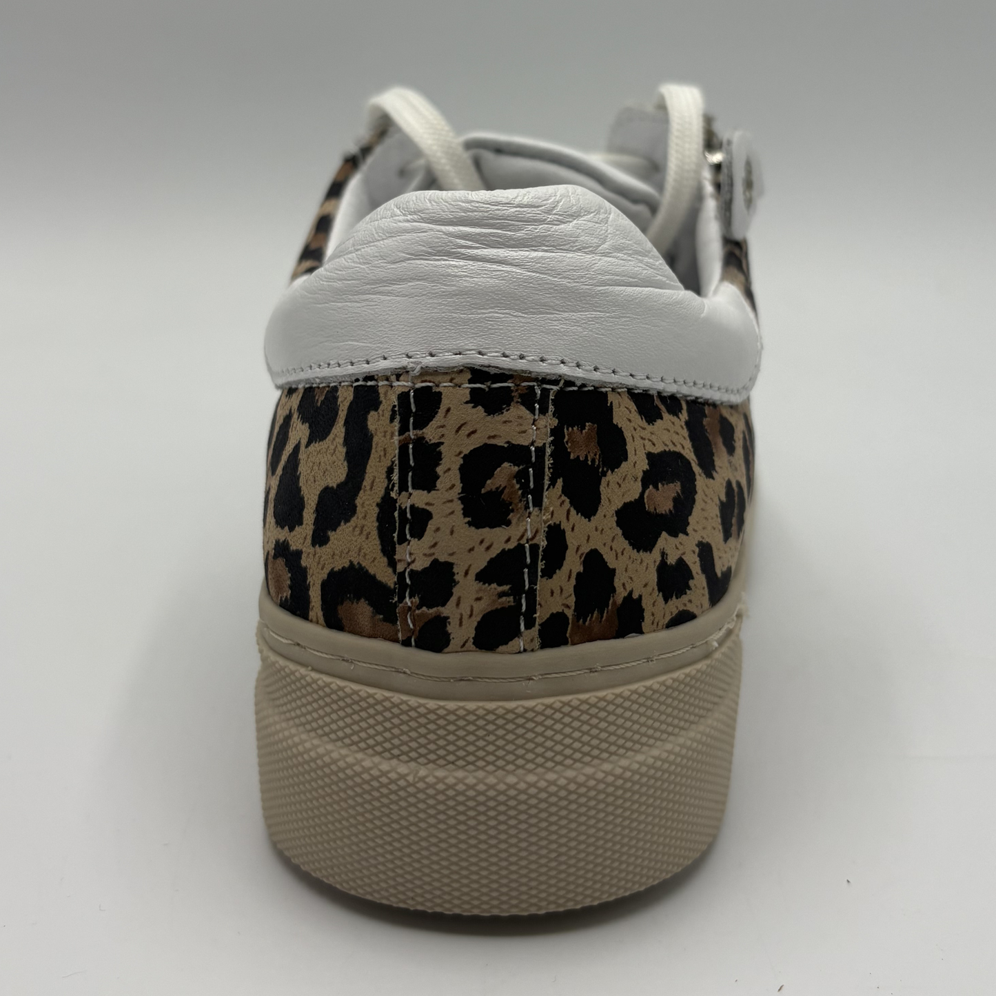 Back view of a leopard print sneaker with a beige rubber outsole