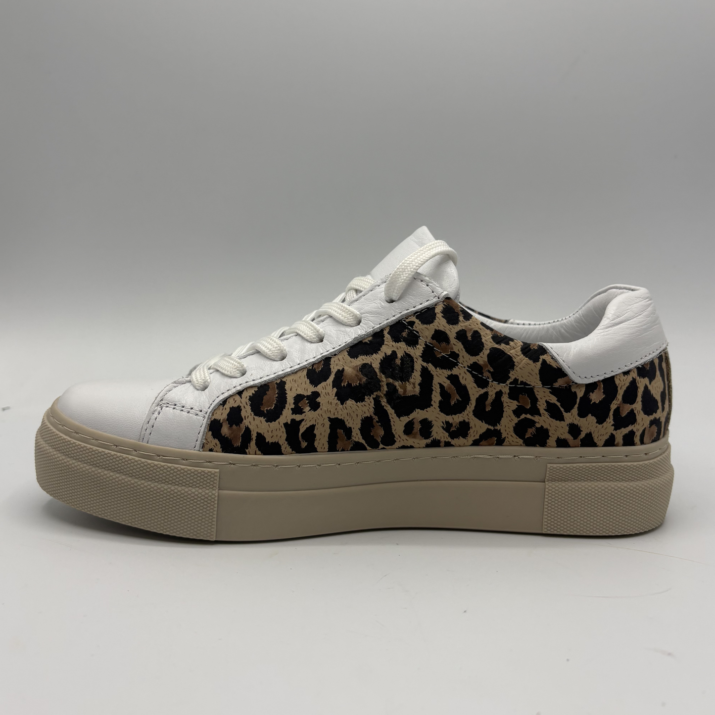 Left view of a leopard print sneaker with a beige rubber outsole