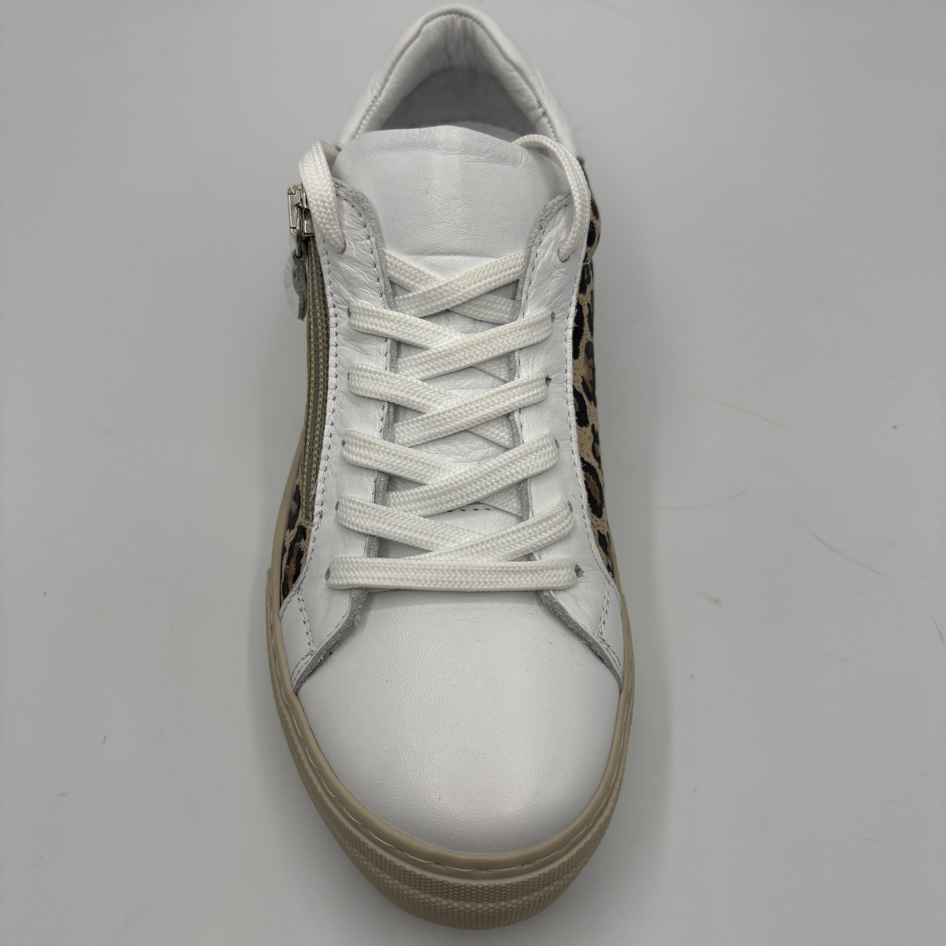 Top view of a leopard print sneaker with a beige rubber outsole