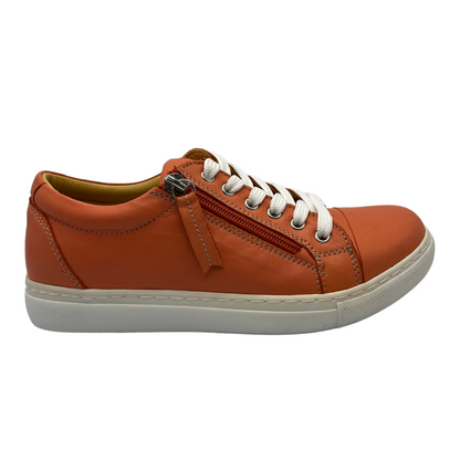 Right facing view of orange leather sneaker with white rubber outsole and white laces.