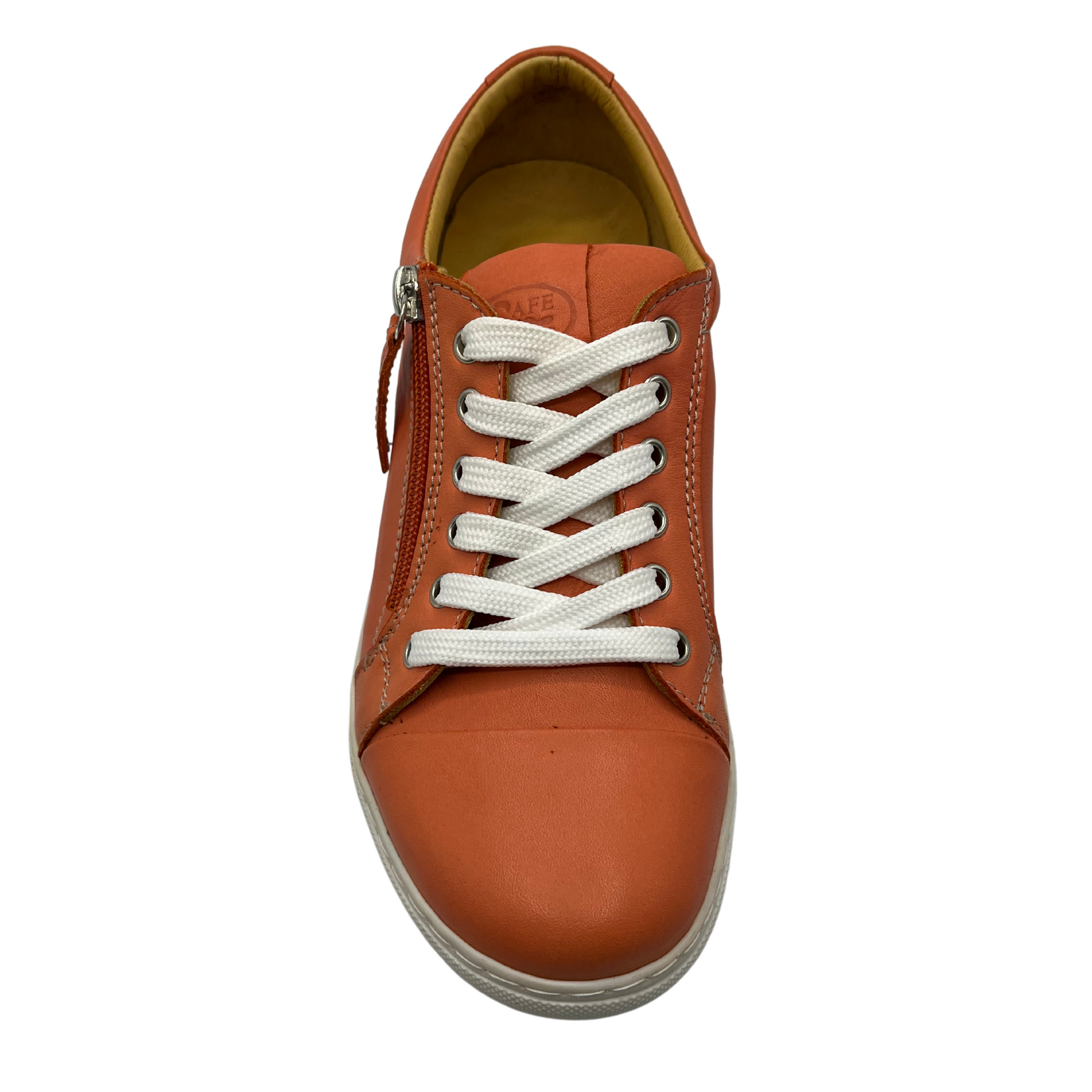 Top view of orange leather sneaker with white rubber outsole and white laces.