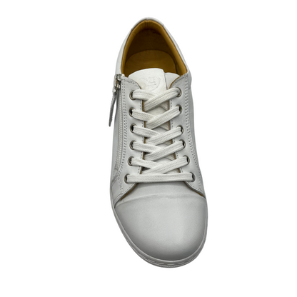 Top view of white leather sneaker with white rubber outsole and white laces.
