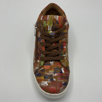 Top view of a leather sneaker with a side zip closure and white rubber outsole