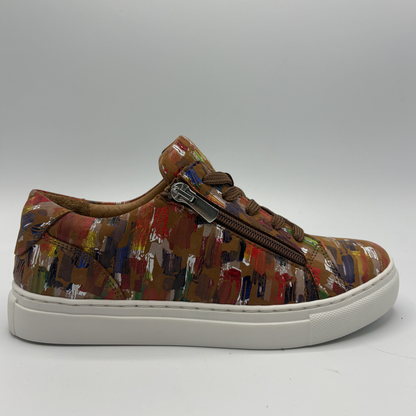 Right facing view of a leather sneaker with a side zip closure and white rubber outsole