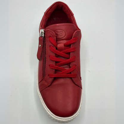 Top view of a red leather sneaker with a white rubber outsole