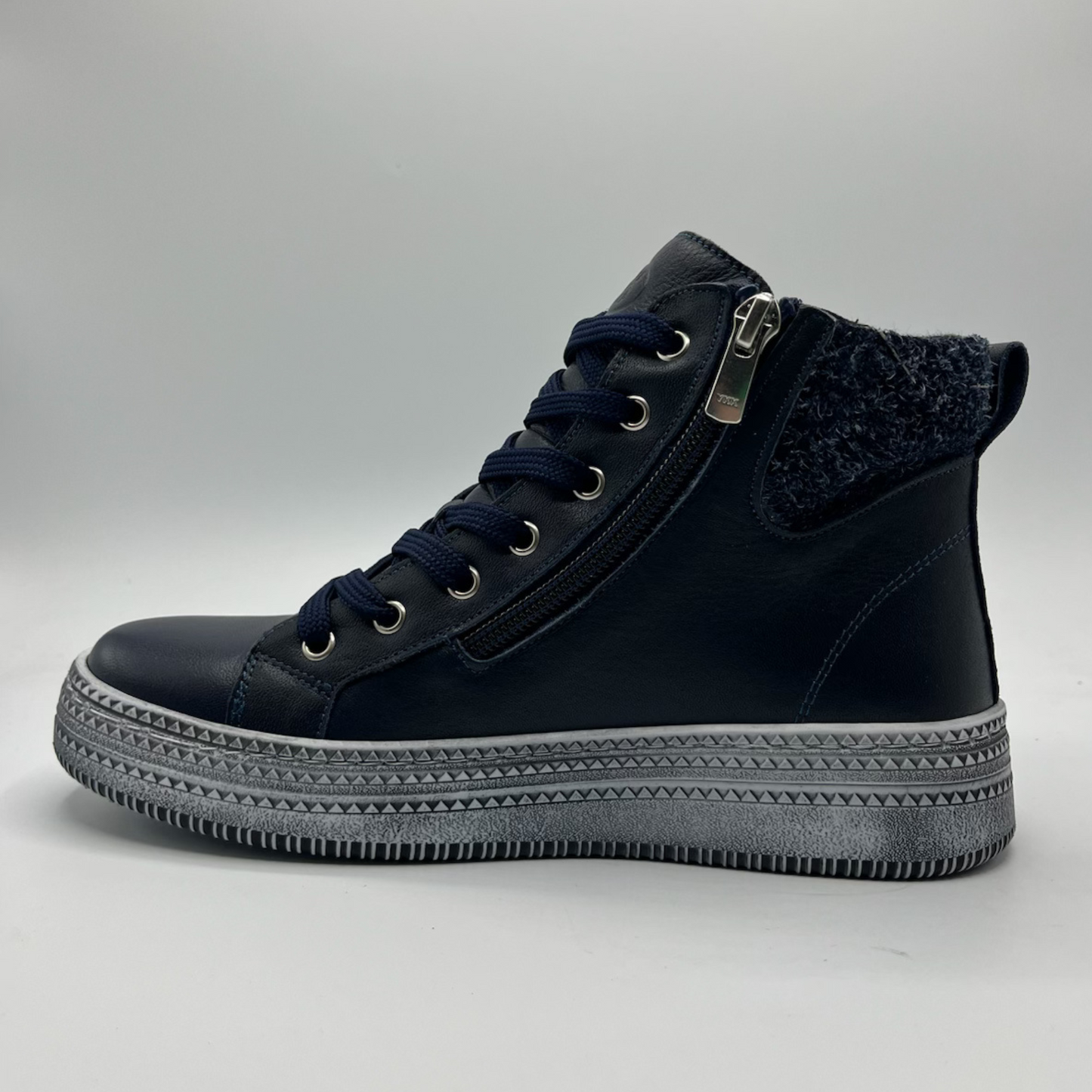 Navy high-top sneaker with gray sole on a light gray background