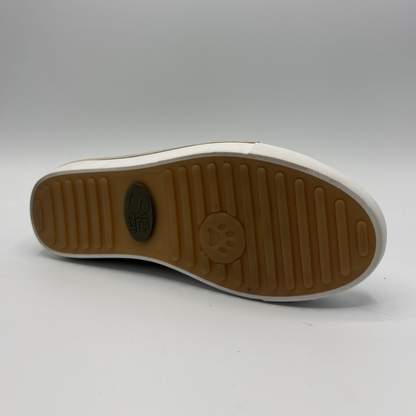 Bottom view of a beige perforated leather sneaker with a white rubber outsole