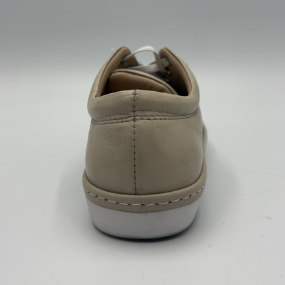 Back view of a beige perforated leather sneaker with a white rubber outsole