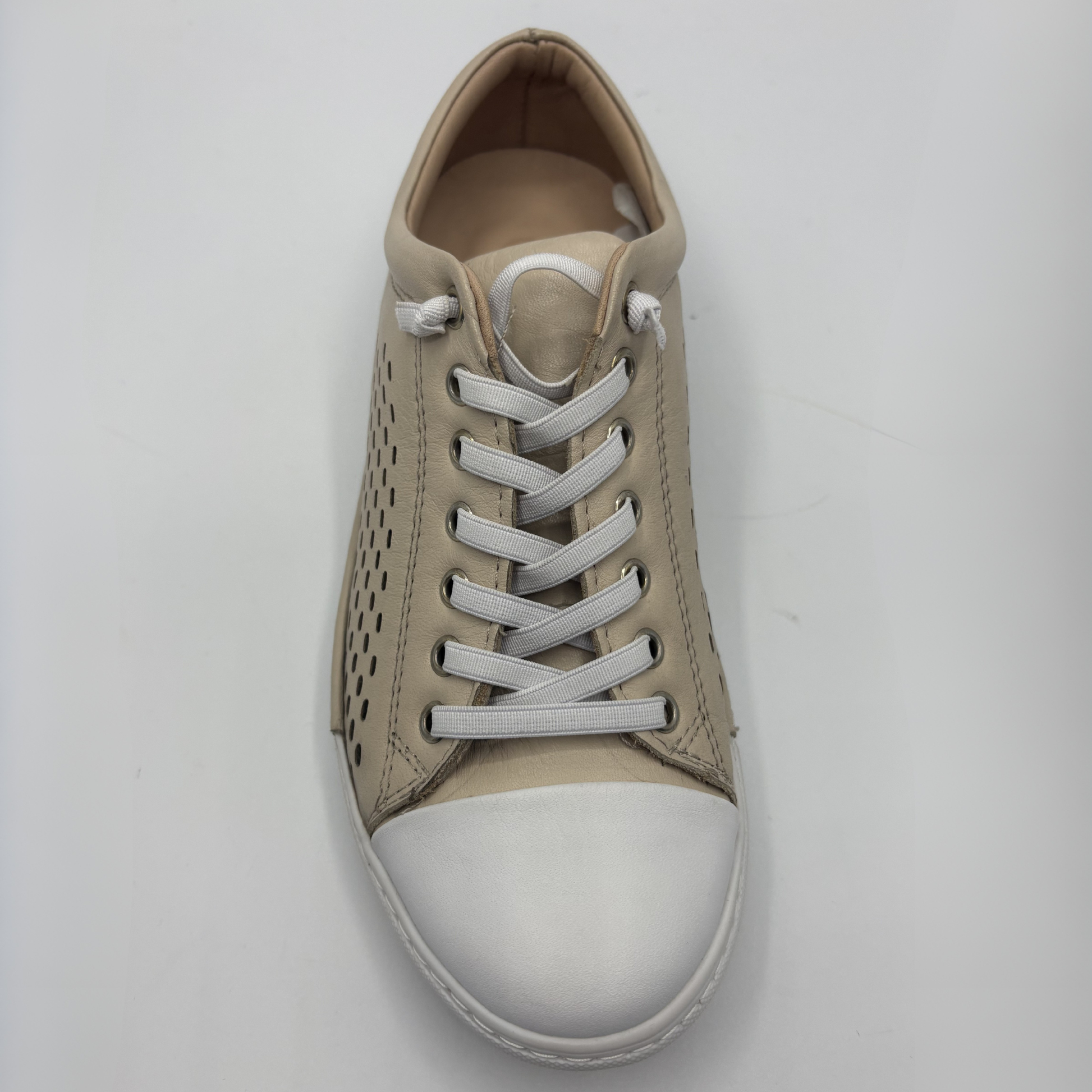 Top view of a beige perforated leather sneaker with a white rubber outsole
