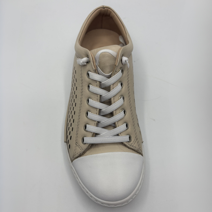Top view of a beige perforated leather sneaker with a white rubber outsole