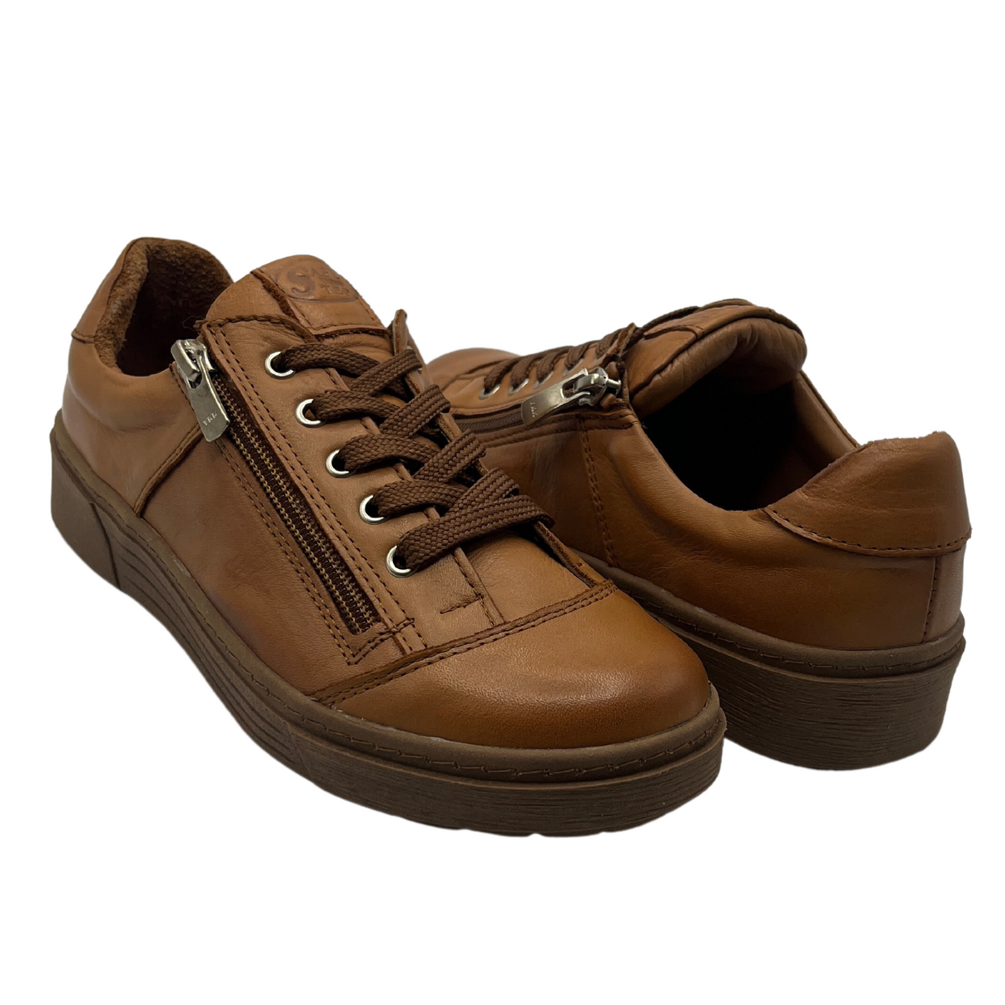 View of a pair of brown leather sneakers with side zipper closures and matching laces