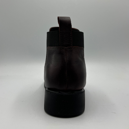 Black leather boot on a gray background