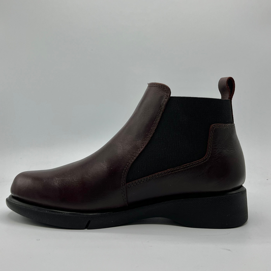 Brown leather Chelsea boot on a light gray background