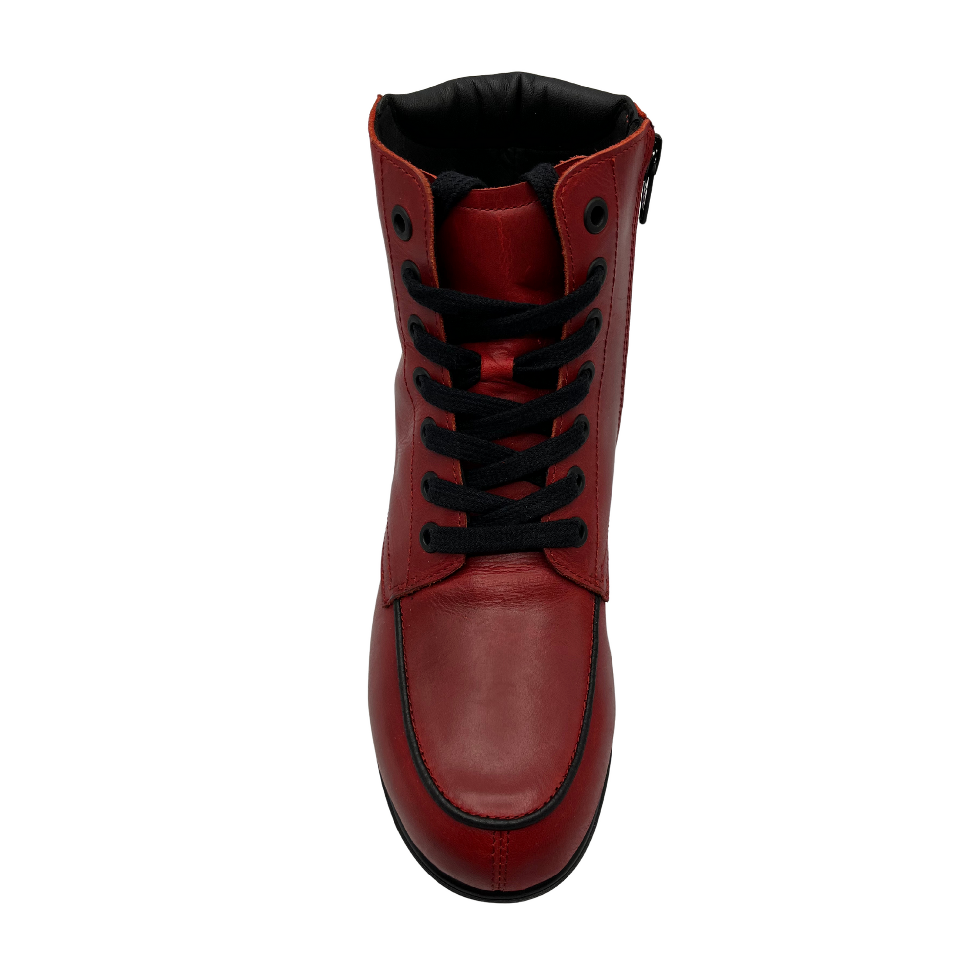 Top view of red leather short boot with black laces and short block heel on black rubber outsole