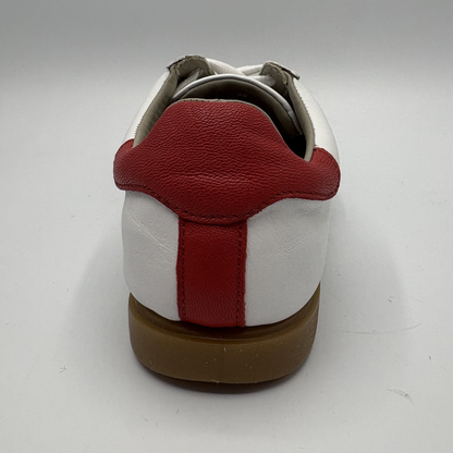 White and red shoe on a gray background