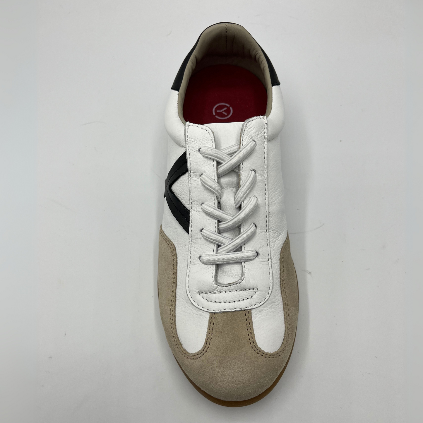 Top view of a leather and suede sneaker with a brown rubber outsole and a padded collar.